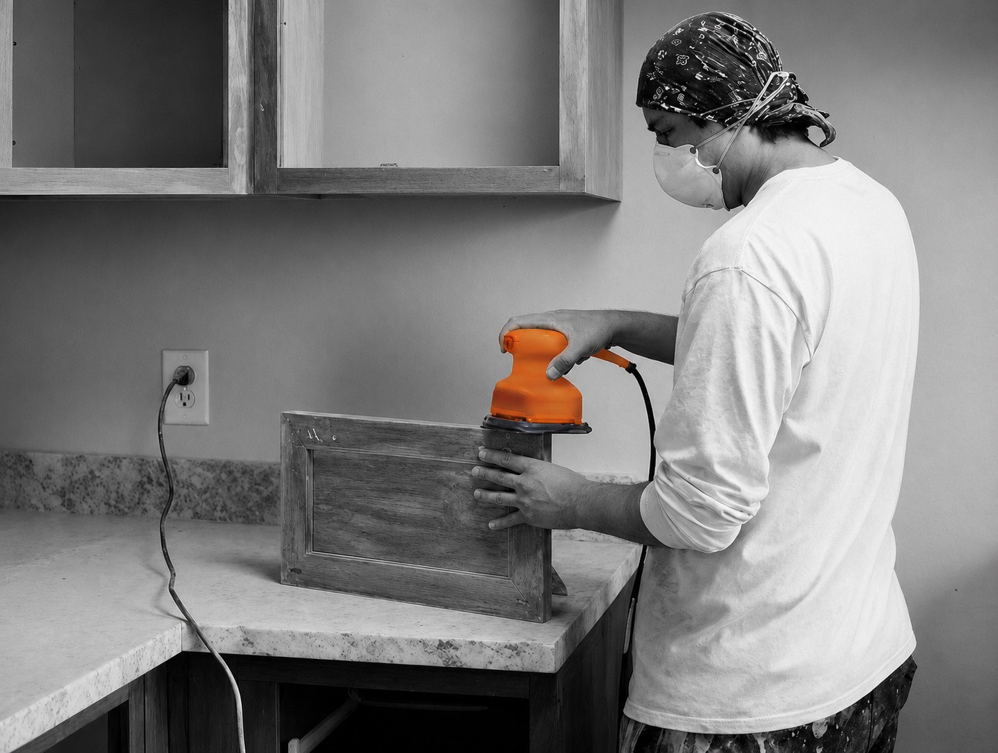 Gorilla craftsman sanding cabinetry during a unit renovation